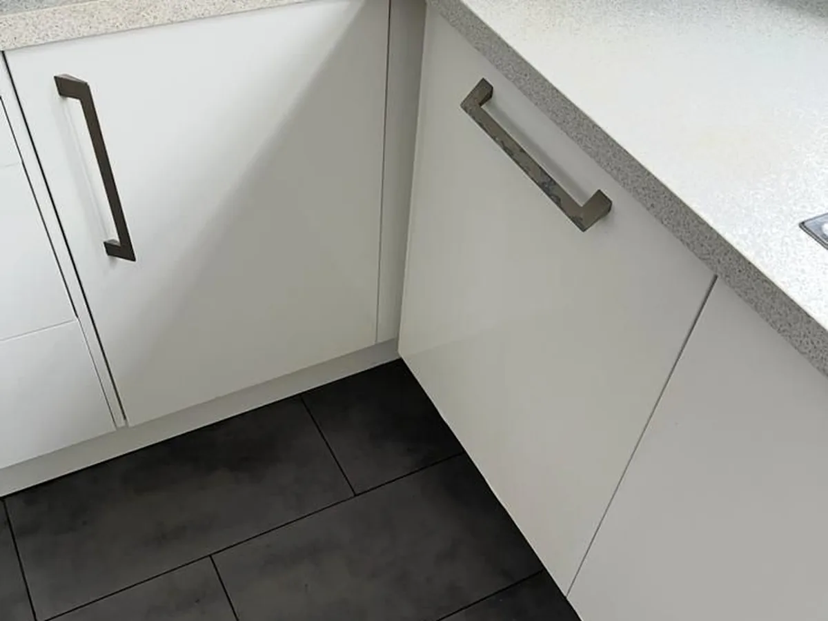 The same kitchen after cleaning, with the units wiped down and the floor washed