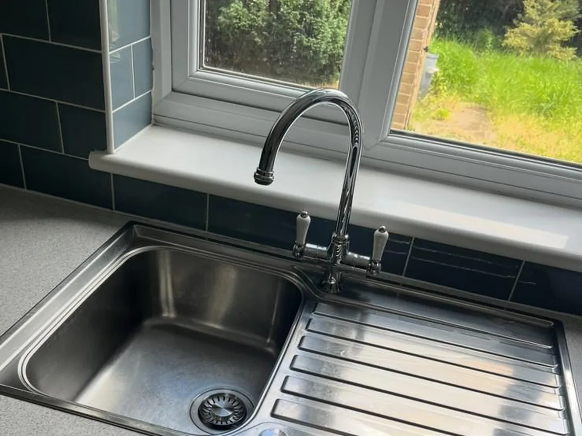 The same sink and tap after cleaning, polished and clear of scale