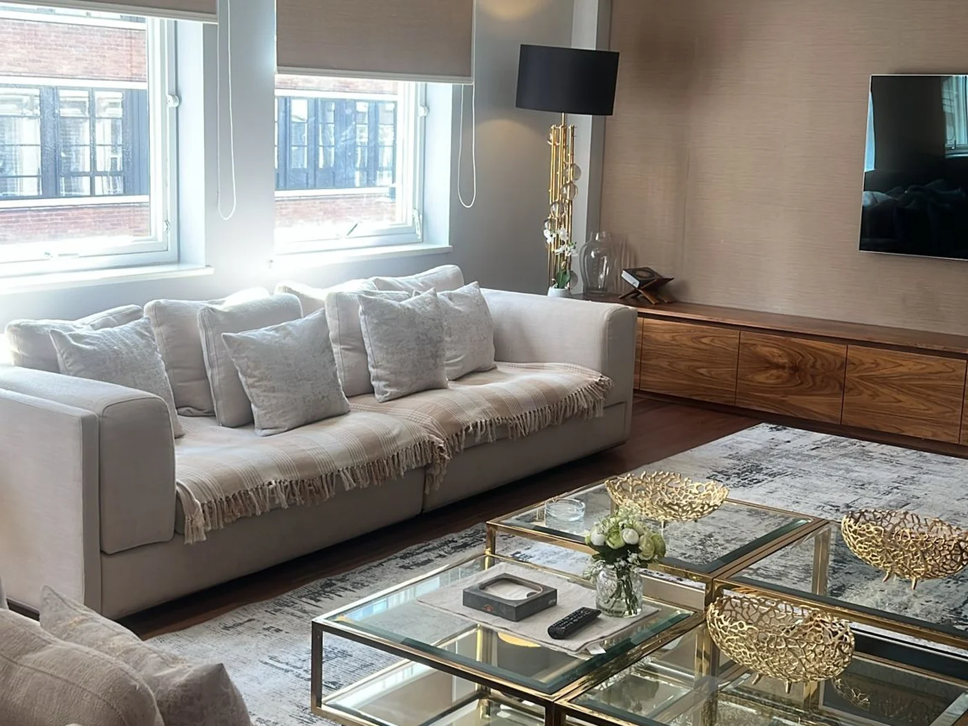 A bright living room after a full clean by Apex Clean Group, with a spotless sofa, polished glass table and clear surfaces