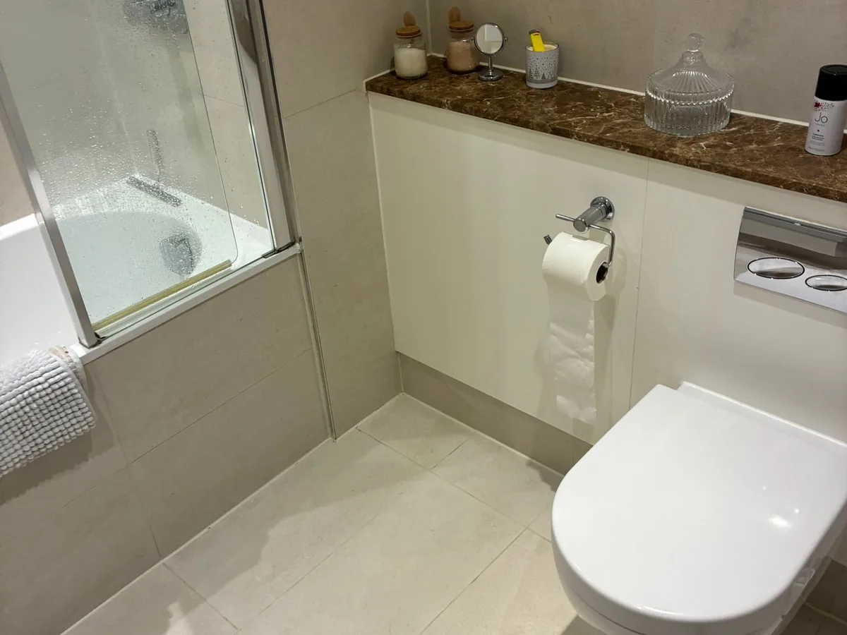 A bathroom left clean and dry, with the toilet, sill and floor wiped down
