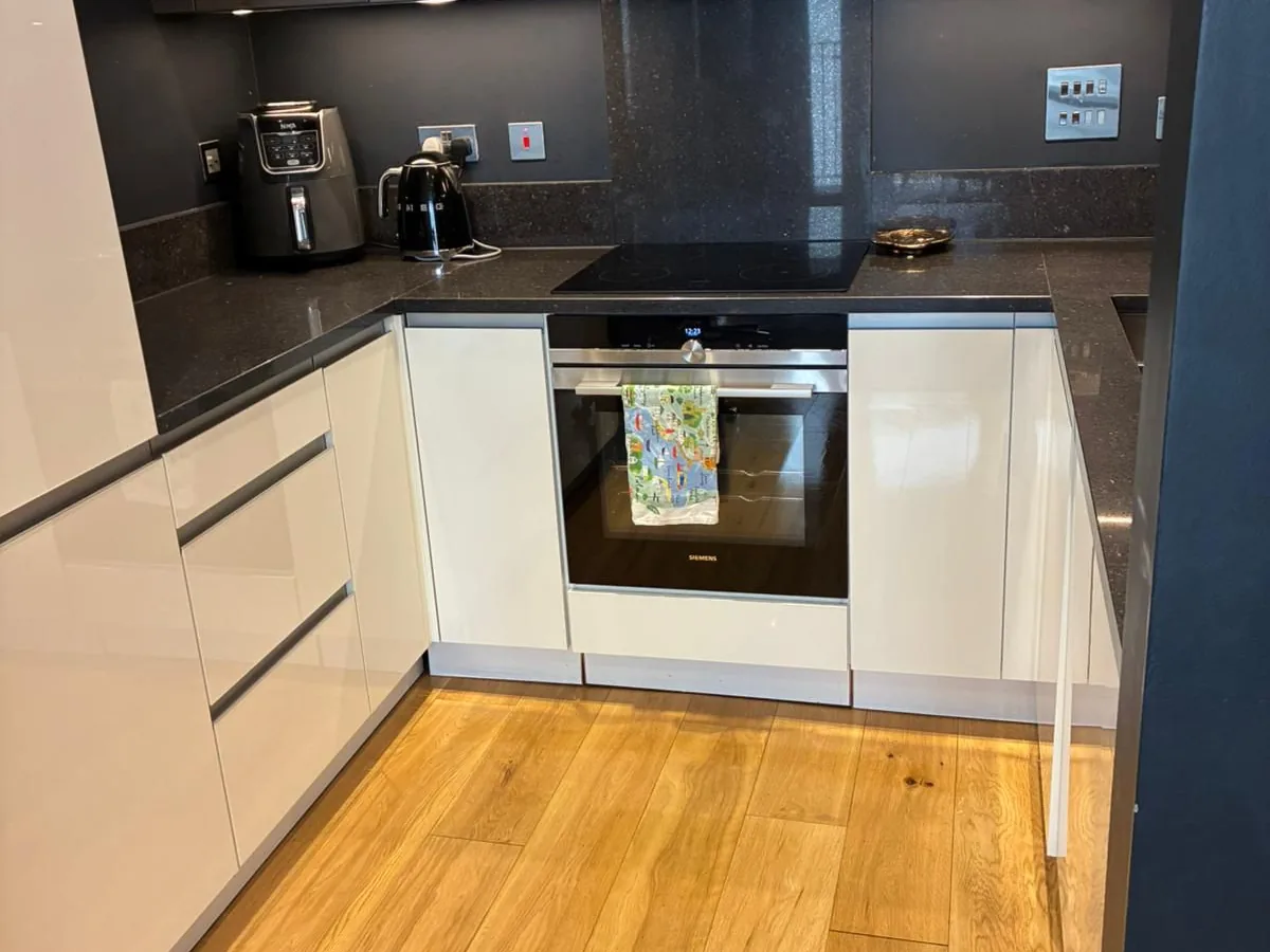 A kitchen with cleared, wiped worktops and polished appliances after a visit