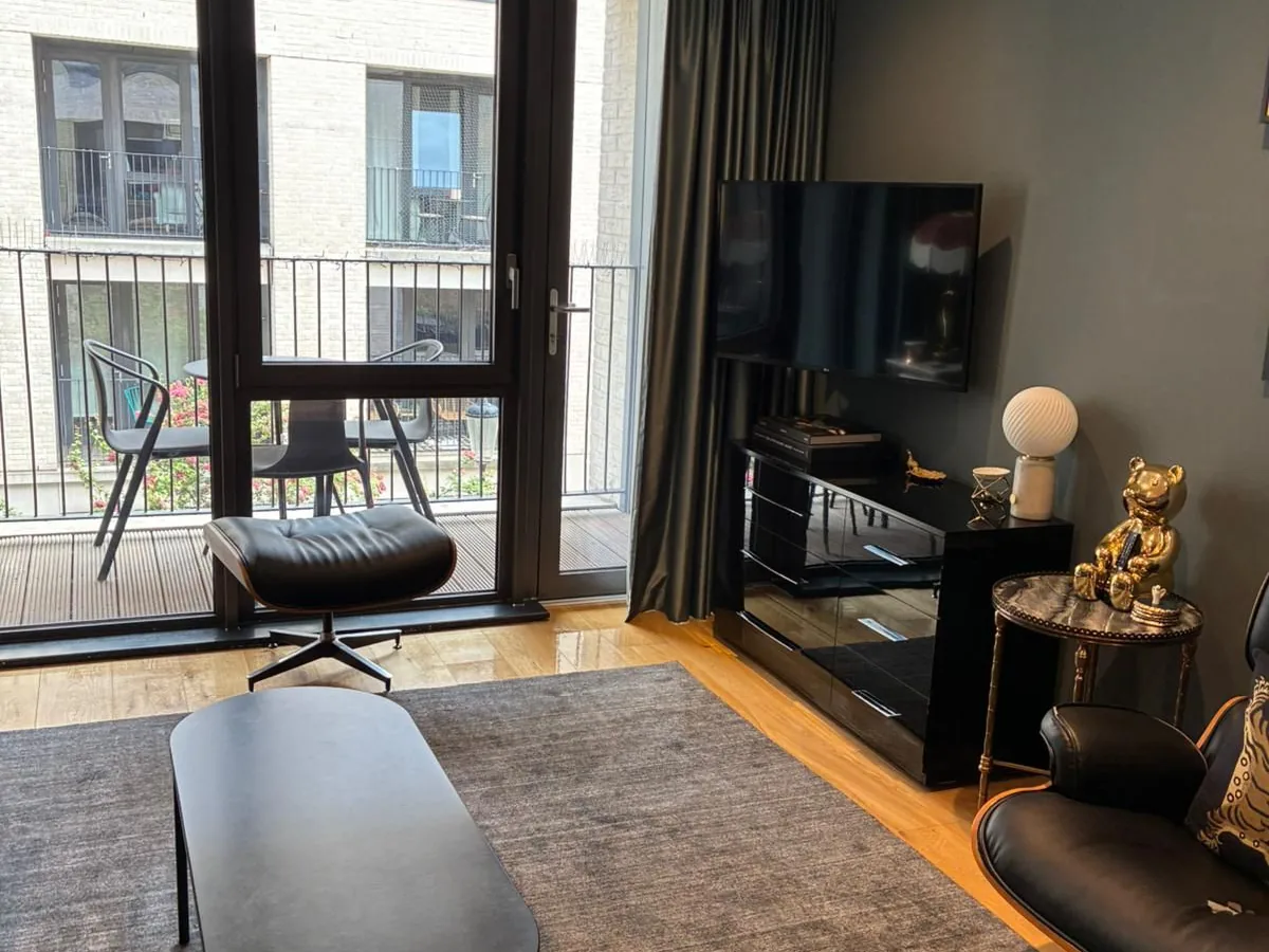 A living room kept on top of by a regular clean, with clear surfaces and a vacuumed floor